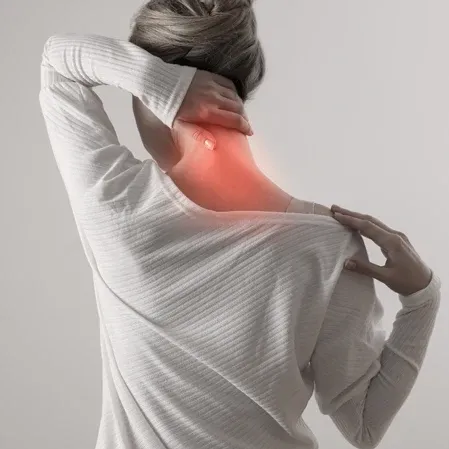 A woman holding her neck in pain